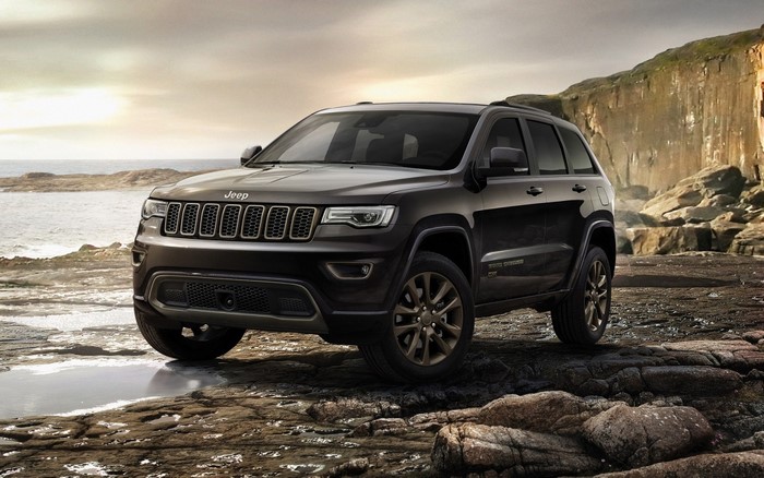 Dark Jeep Grand Cherokee on rocky shore