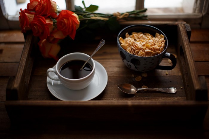 Breakfast tray with coffee, cereal, and roses
