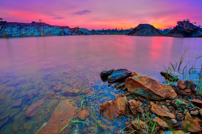 Lake with rocky shore at sunset