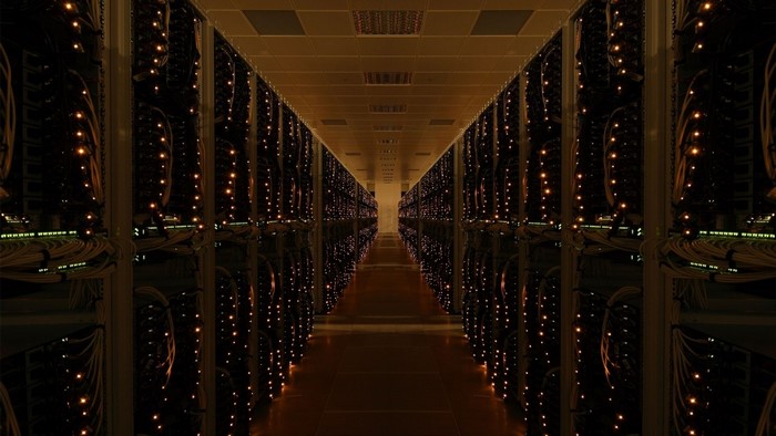 Server room with rows of illuminated racks