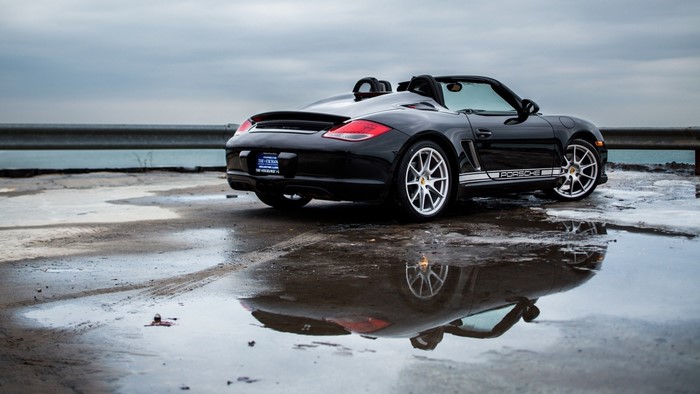 Black Porsche Boxster Convertible on Wet Surface