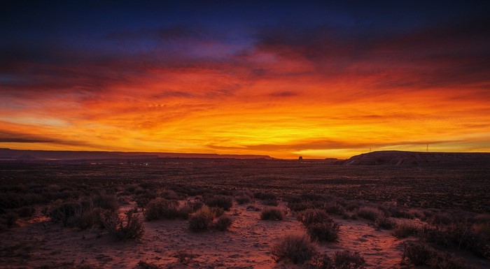 Desert landscape at sunset with vibrant sky