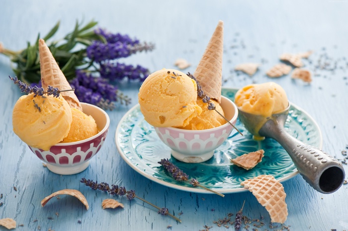 Orange ice cream with lavender and waffle cones