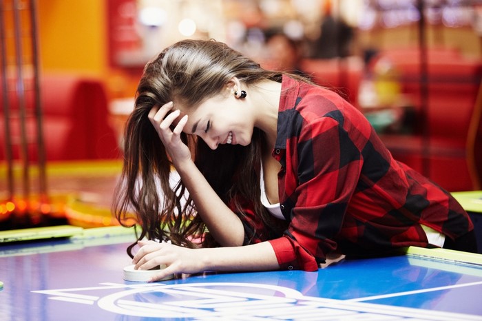 Woman playing air hockey