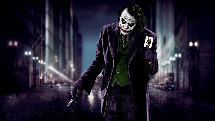 Joker from The Dark Knight holding a playing card