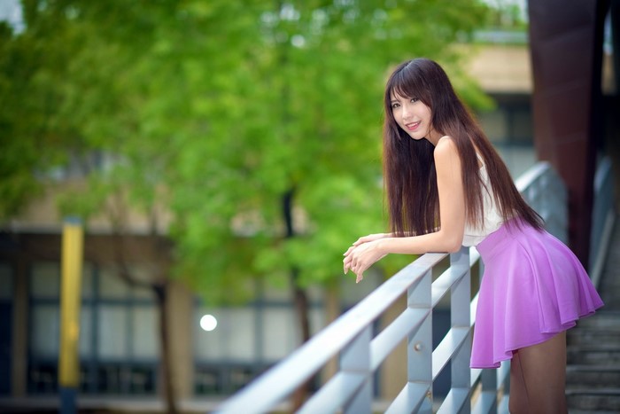 Smiling Woman in Purple Skirt Outdoors
