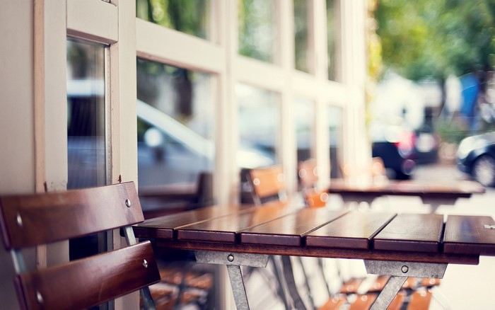 Outdoor cafe tables and chairs with reflections
