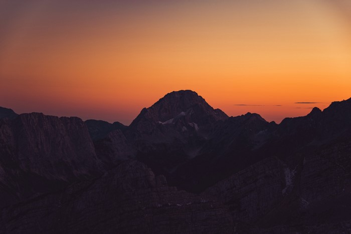 Mountains at sunset with orange sky
