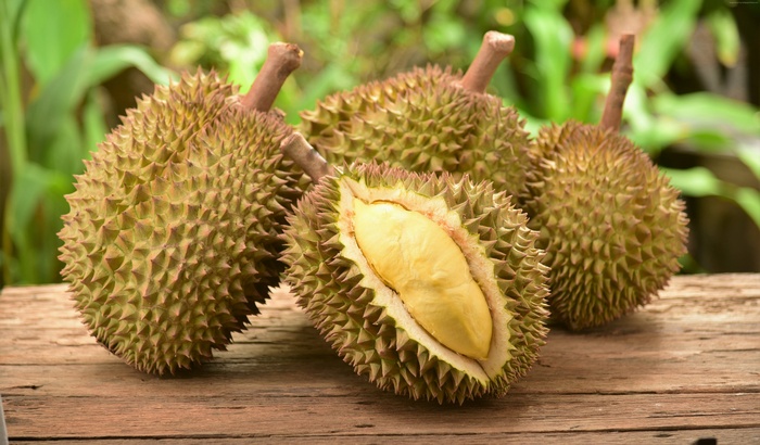 Several durian fruits on a wooden table