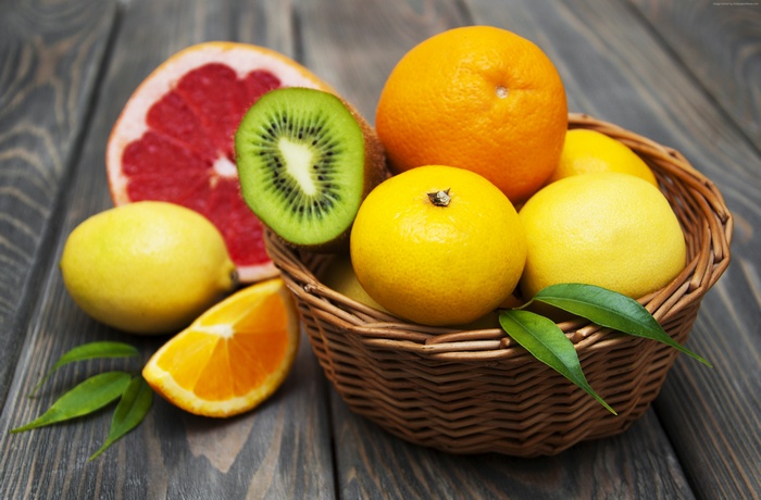 Assortment of Citrus Fruits and Kiwi in a Basket