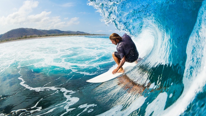 Surfer riding a wave in the ocean