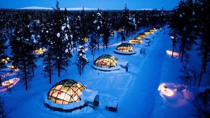 Igloo hotel in snowy forest at night, Lapland