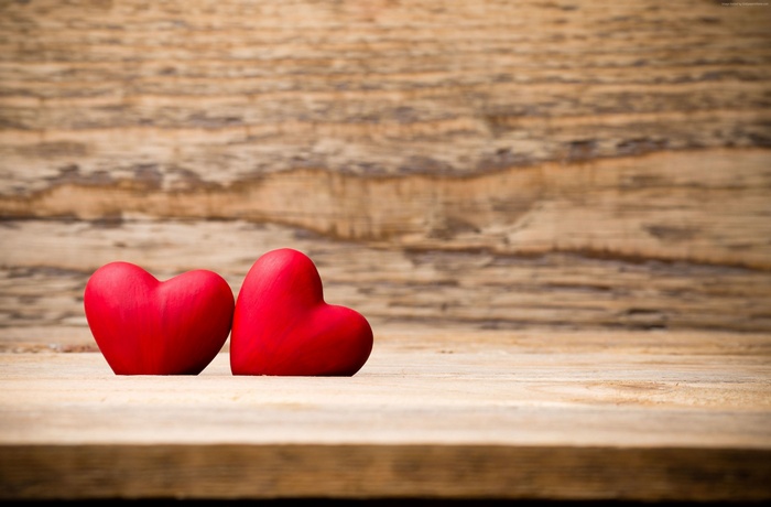Two red hearts on a wooden background