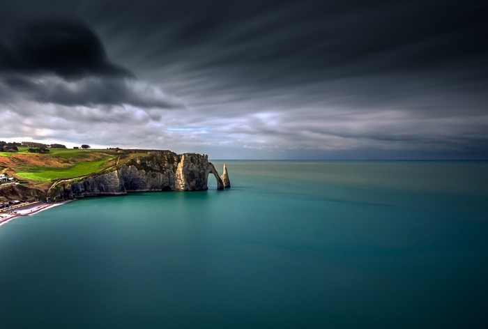 Etretat cliffs and sea under stormy sky