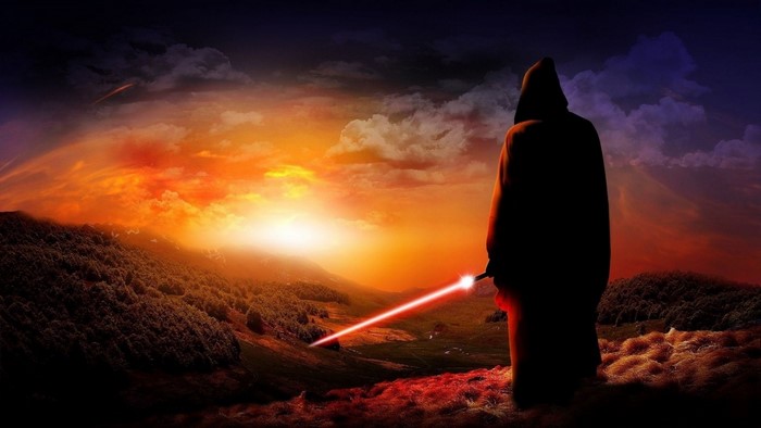 Figure with lightsaber at sunset