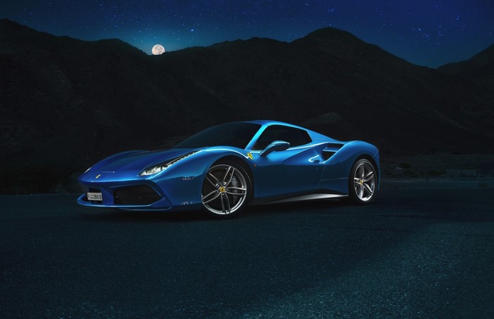 Blue Ferrari 488 GTB parked at night under the moon
