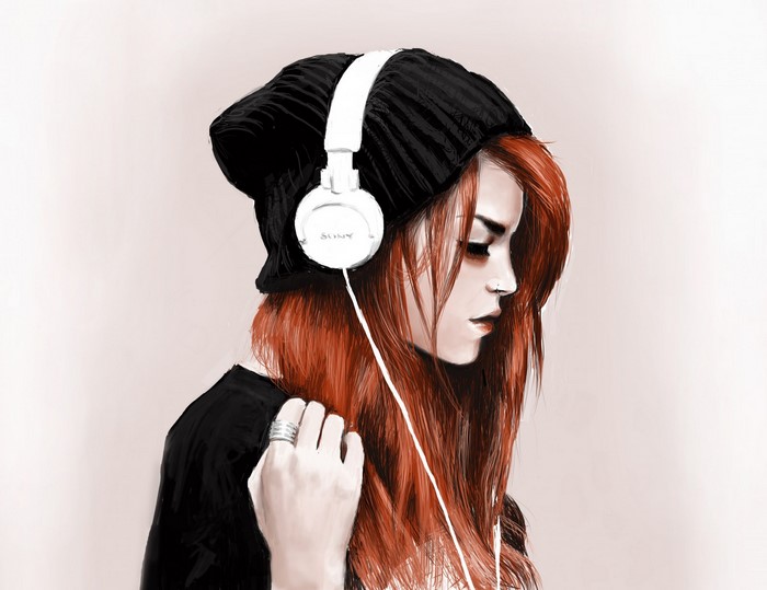 Woman with red hair wearing headphones and beanie