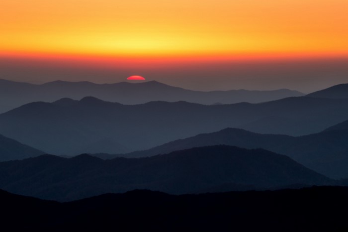 Sunset over layered mountain ranges