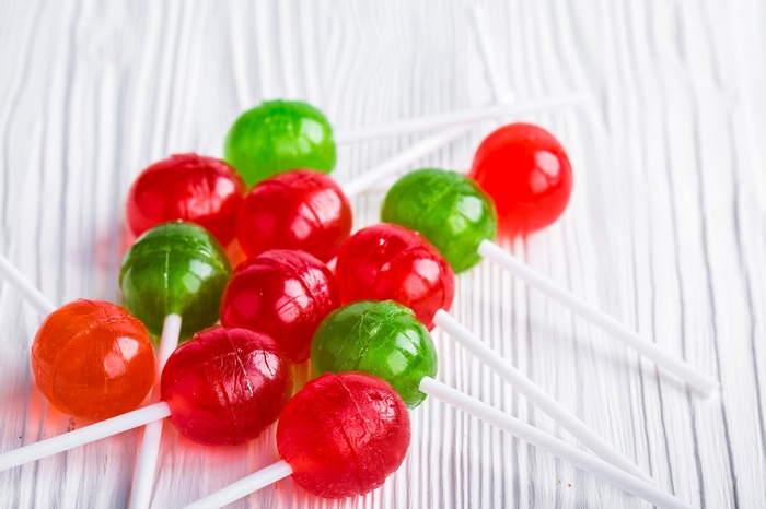 Assorted Lollipops on White Wooden Surface
