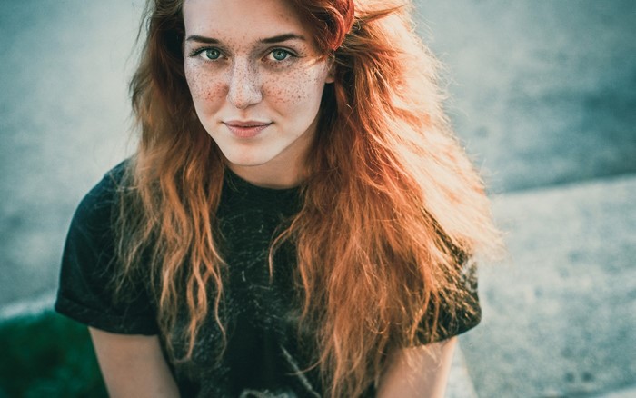 Young woman with red hair and freckles