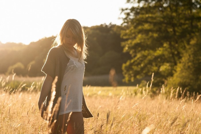 Woman in a field at sunset