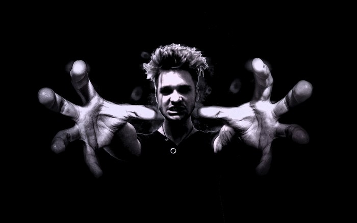 Man with hands reaching out in monochrome