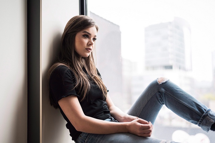 Hailee Steinfeld sitting by a window