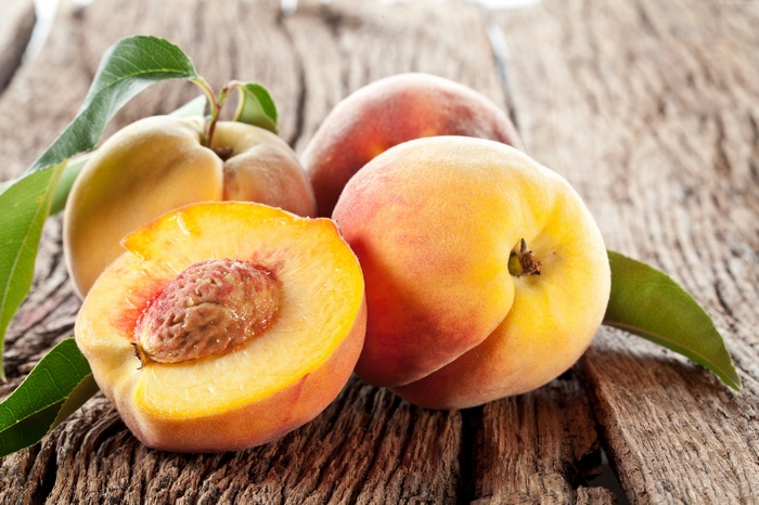 Peaches on a wooden surface