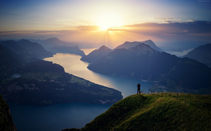 Man overlooking Lake Lucerne, Switzerland at sunrise