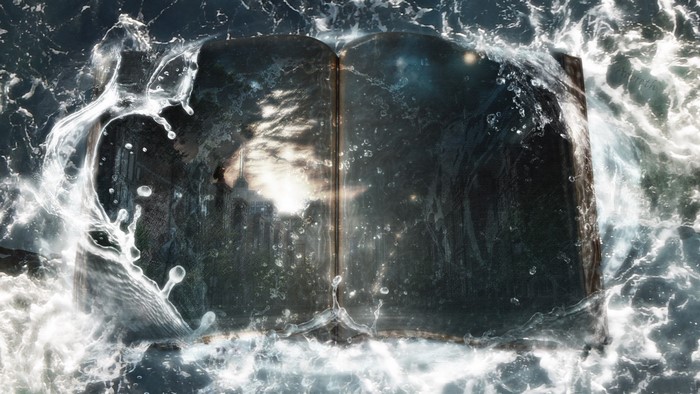 Open book submerged in water with waves