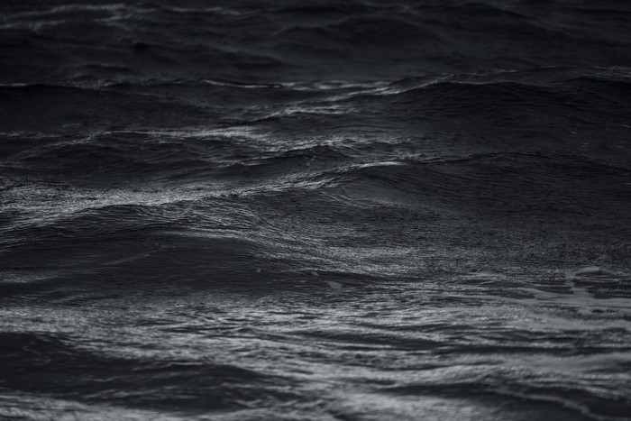 Dark ocean waves with white foam