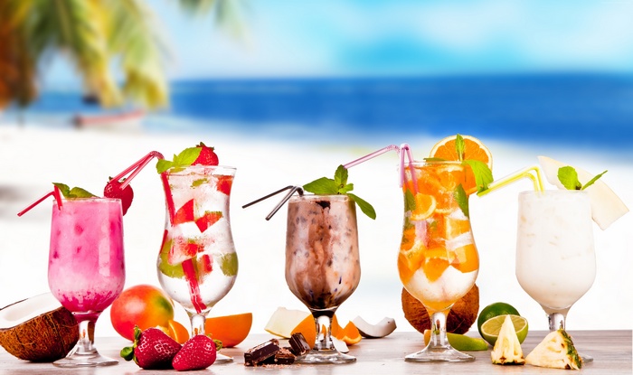 Tropical Cocktails with Fruits on a Beach Background