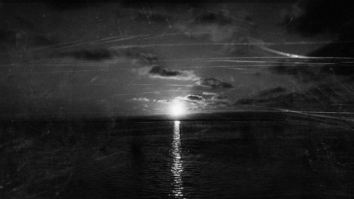 Monochrome sunset over the ocean with clouds