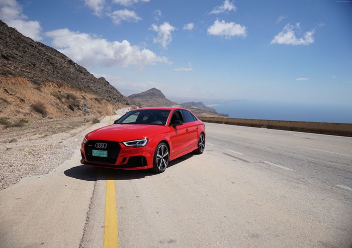 Red Audi RS 3 on a coastal road