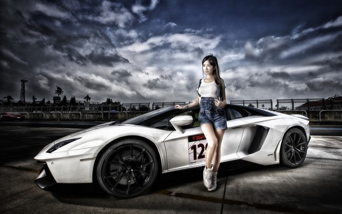 Asian woman posing with a white Lamborghini Aventador