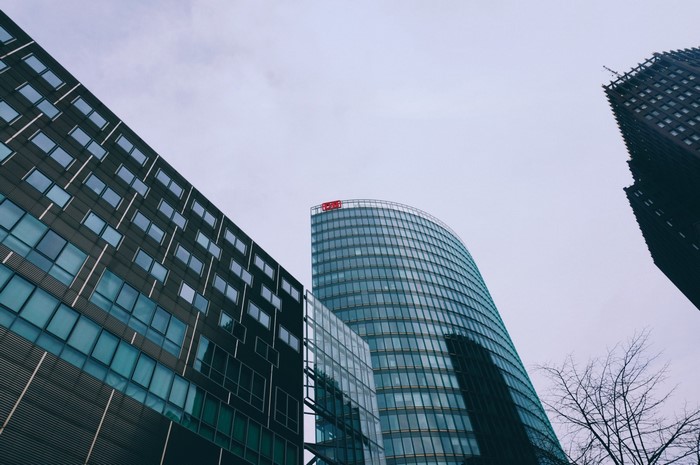 Modern skyscrapers in a city under a cloudy sky