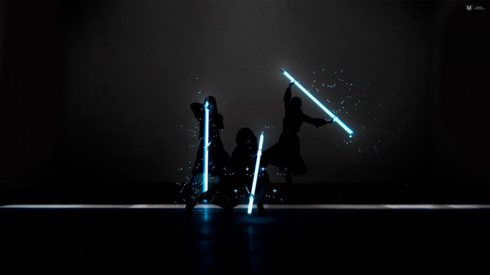 Perfume members performing with lights on stage