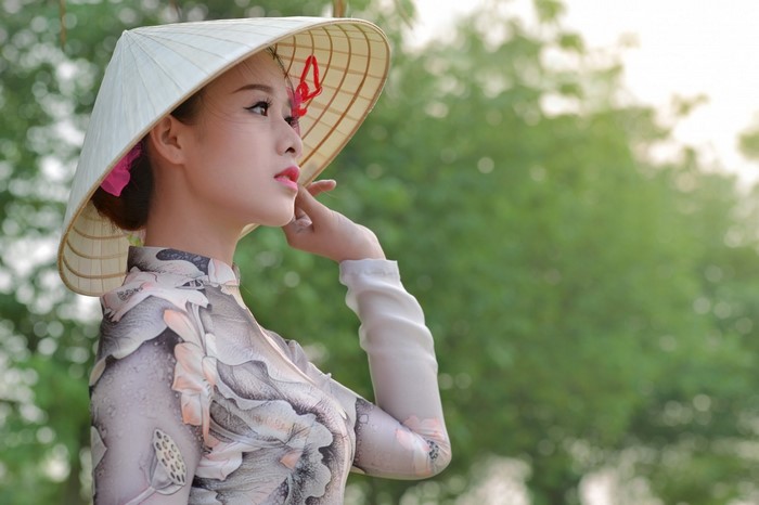 Elegant Woman in Traditional Hat and Dress