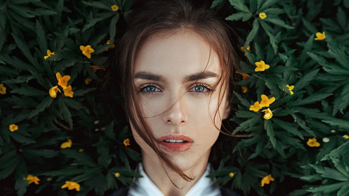 Portrait of Viktoria Vishnevetskaya among yellow flowers and green leaves