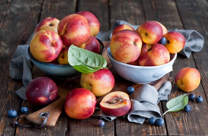 Nectarines and blueberries on wooden table