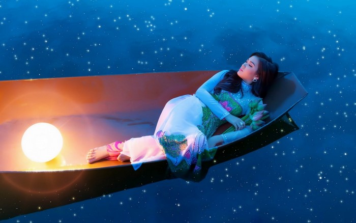 Woman in a boat under a starry sky