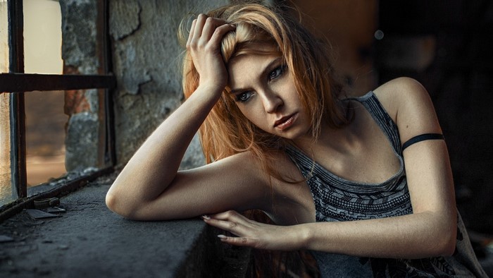 Woman with long hair by a window