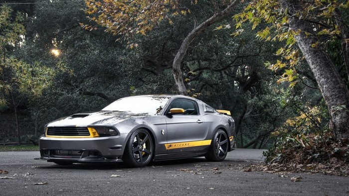 Gray Ford Mustang with yellow accents parked outdoors
