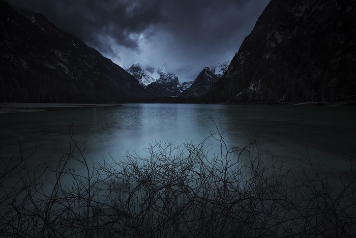 Dark Mountains Reflecting in a Lake at Night