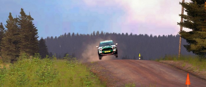 Mini Cooper rally car jumping on a dirt road