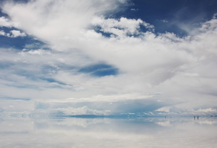 Vast Salt Flats Reflecting a Cloudy Sky