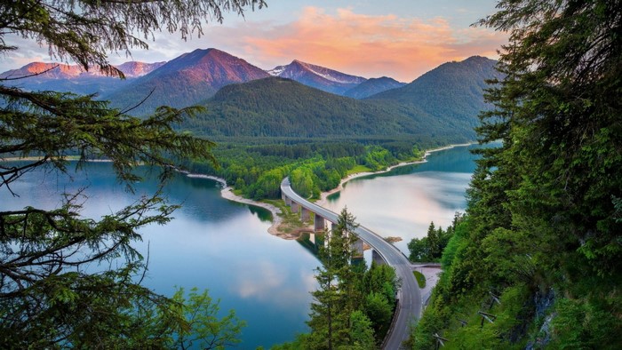 Bridge over a lake with mountains and forest