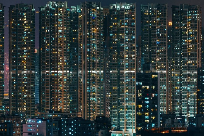 Cityscape at night with illuminated skyscrapers