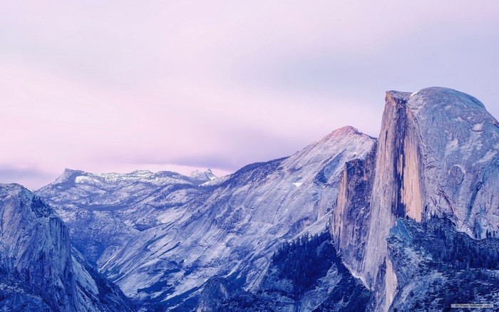 Snow-capped mountains under a pink sky