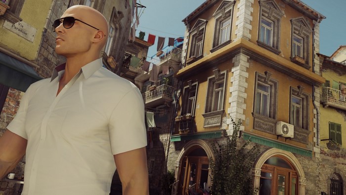 Agent 47 from Hitman in a European street